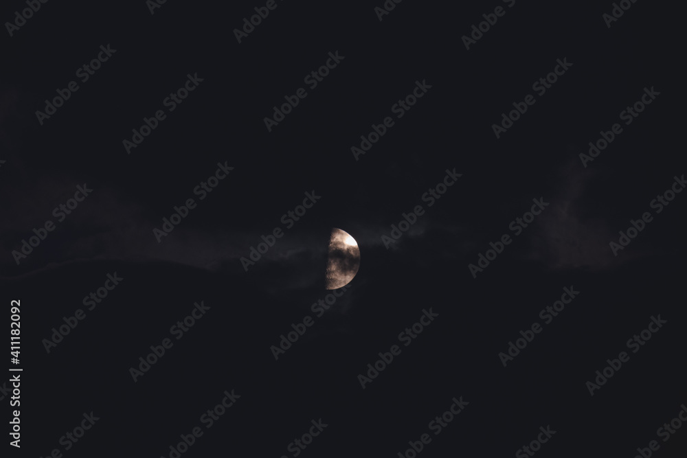 The moon among the stars and clouds