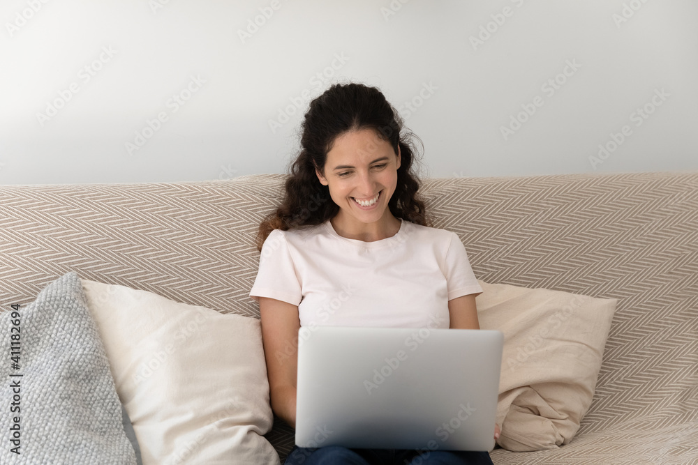 Happy young female satisfied client customer of internet store order buy online make purchases using laptop pc. Positive millennial lady resting on sofa with computer having pleasure browsing internet Happy young female satisfied client customer of internet store order buy online make purchases using laptop pc. Positive millennial lady resting on sofa with computer having pleasure browsing internet