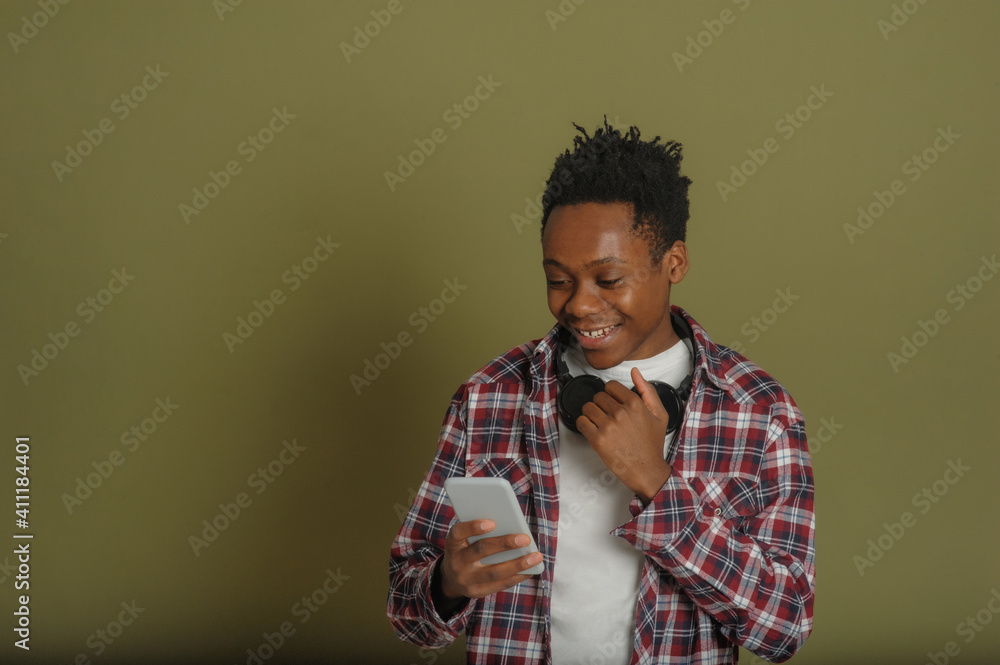 Fototapeta premium young african american guy talking on the phone on a green background