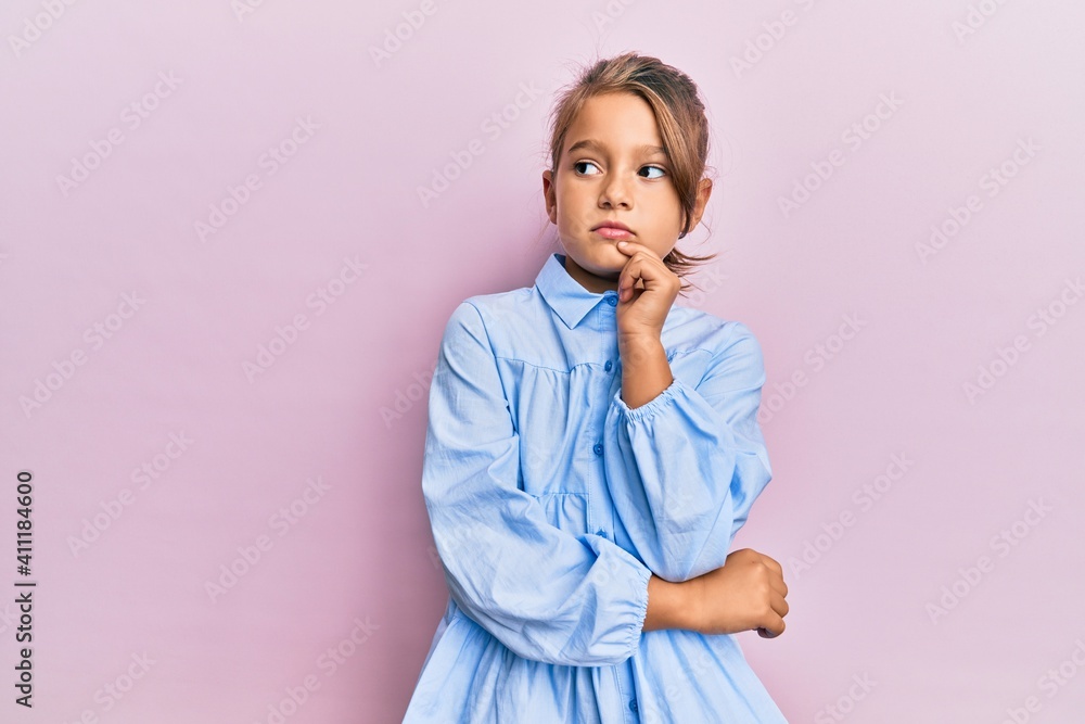 Little beautiful girl wearing casual clothes thinking concentrated about doubt with finger on chin and looking up wondering Little beautiful girl wearing casual clothes thinking concentrated about doubt with finger on chin and looking up wondering