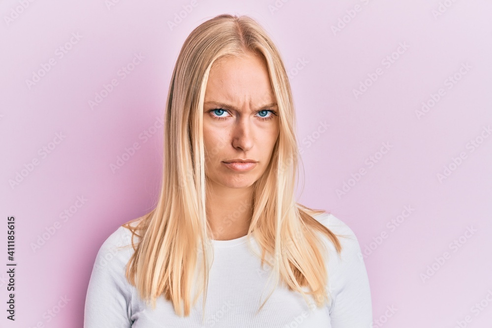 Young blonde girl wearing casual clothes skeptic and nervous, frowning upset because of problem. negative person. Young blonde girl wearing casual clothes skeptic and nervous, frowning upset because of problem. negative person.