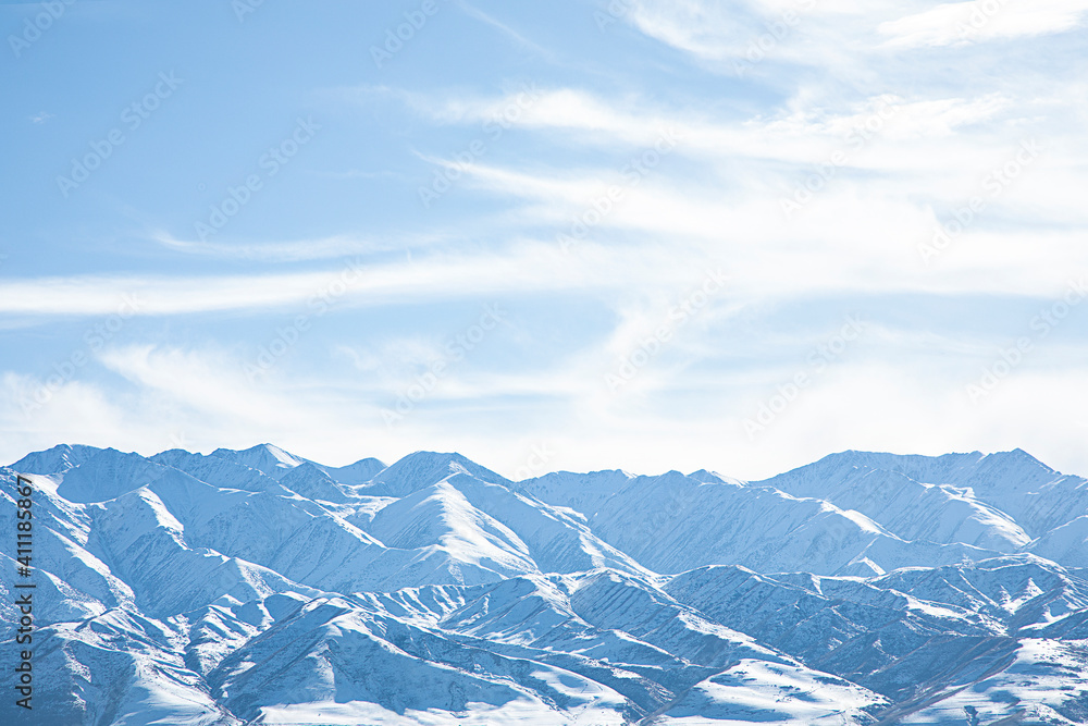 snowy mountains with blue sky and clouds