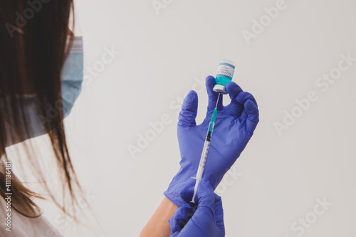 Nurse or doctor with gloves prepare vaccination srynge for COVID-19 and VUI 202012 1or flu photo