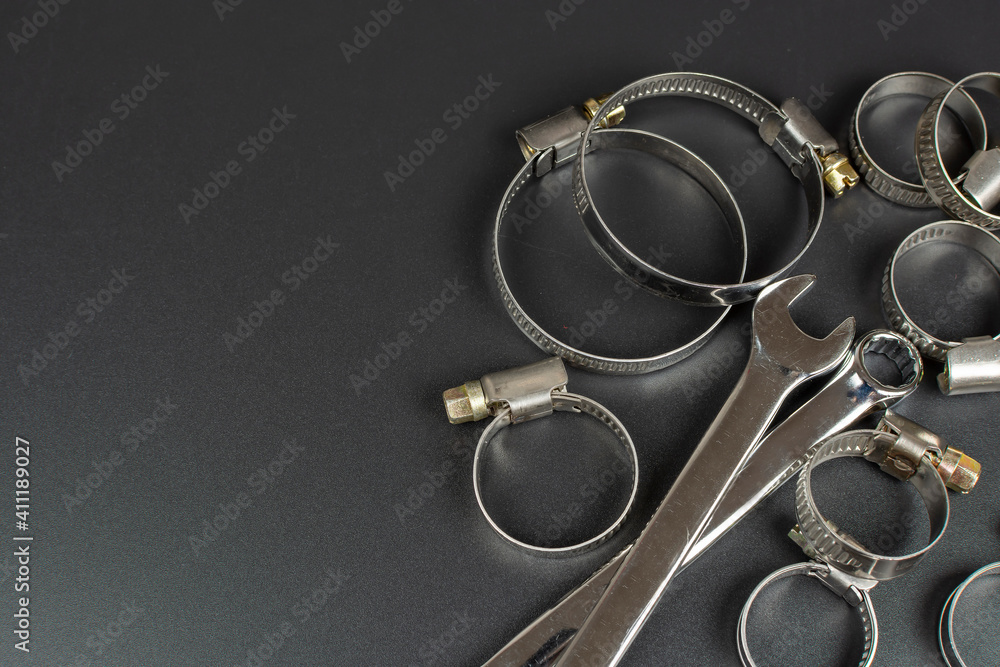 metal clamps for hose connection and tool isolated on black background metal clamps for hose connection and tool isolated on black background