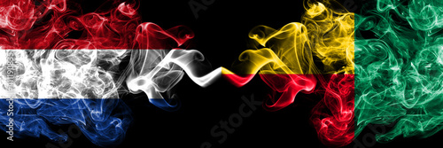 Netherlands vs Benin, Beninese smoky mystic flags placed side by side. Thick colored silky abstract smoke flags.
