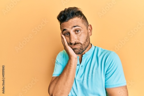 Handsome man with beard wearing casual clothes thinking looking tired and bored with depression problems with crossed arms.