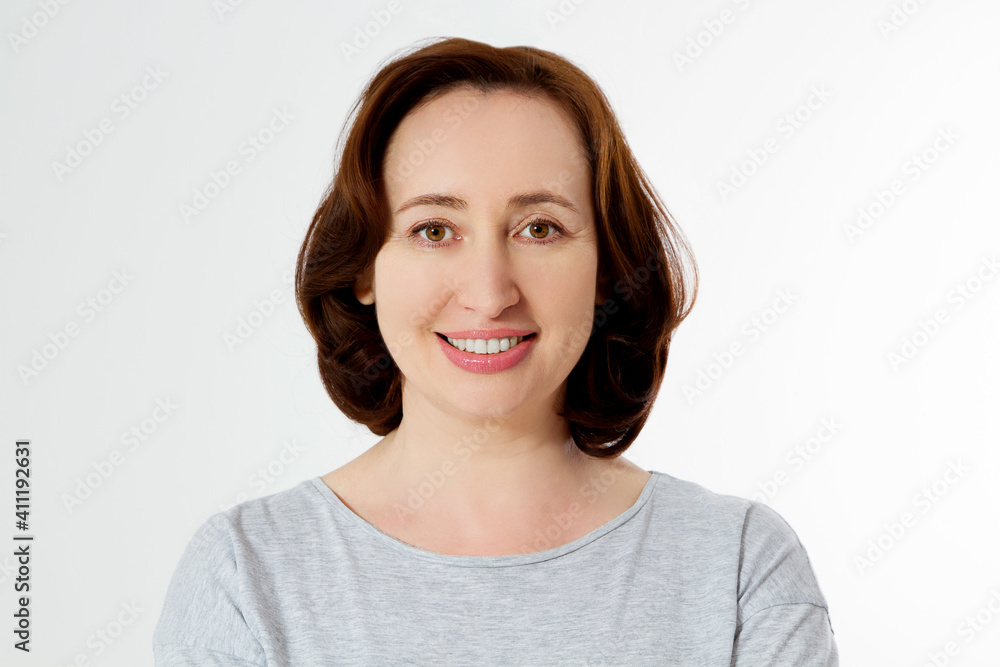 Closeup beautiful middle aged woman face isolated on white background with copy space. Anti aging lifting treatment and skincare routine. Menopausal female period and healthy anti-aging lifestyle Closeup beautiful middle aged woman face isolated on white background with copy space. Anti aging lifting treatment and skincare routine. Menopausal female period and healthy anti-aging lifestyle