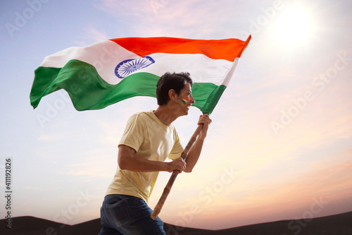 Fotografija young man running with indian flag in excitement, independence day