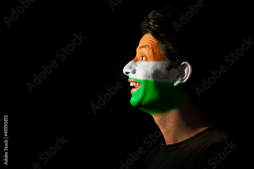 Canvas Print man with tricolour painted on his face smiling with enthusiasm, independence day