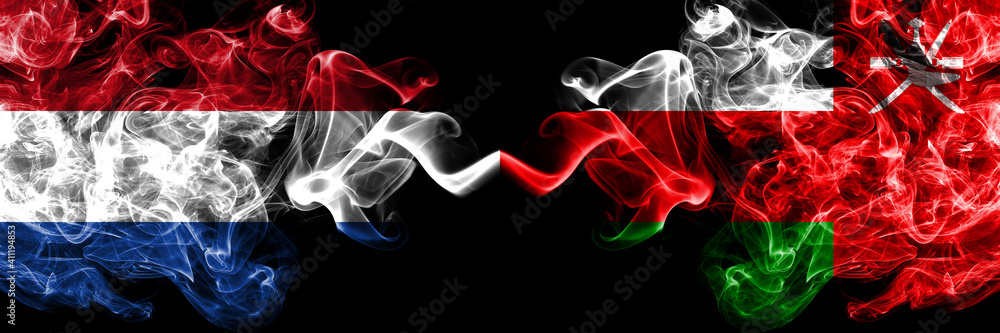 Netherlands vs Oman smoky mystic flags placed side by side. Thick colored silky abstract smoke flags. Netherlands vs Oman smoky mystic flags placed side by side. Thick colored silky abstract smoke flags.