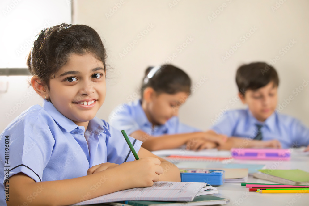 school girl sitting in class and smiling school girl sitting in class and smiling