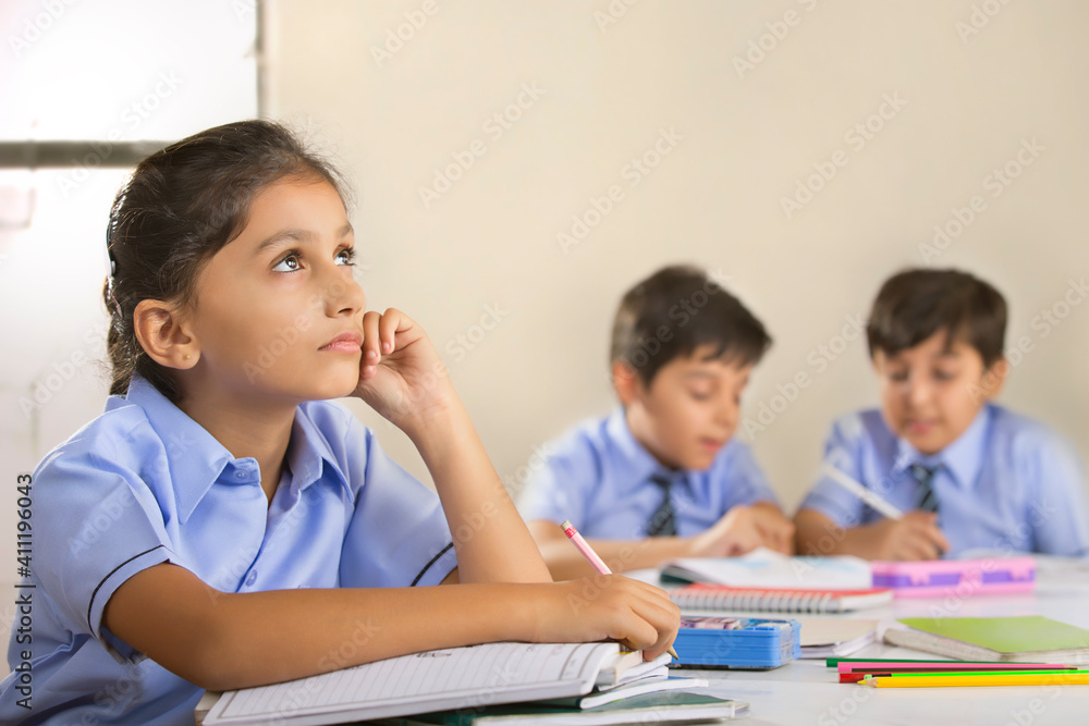 school girl thinking about something while studying in class school girl thinking about something while studying in class
