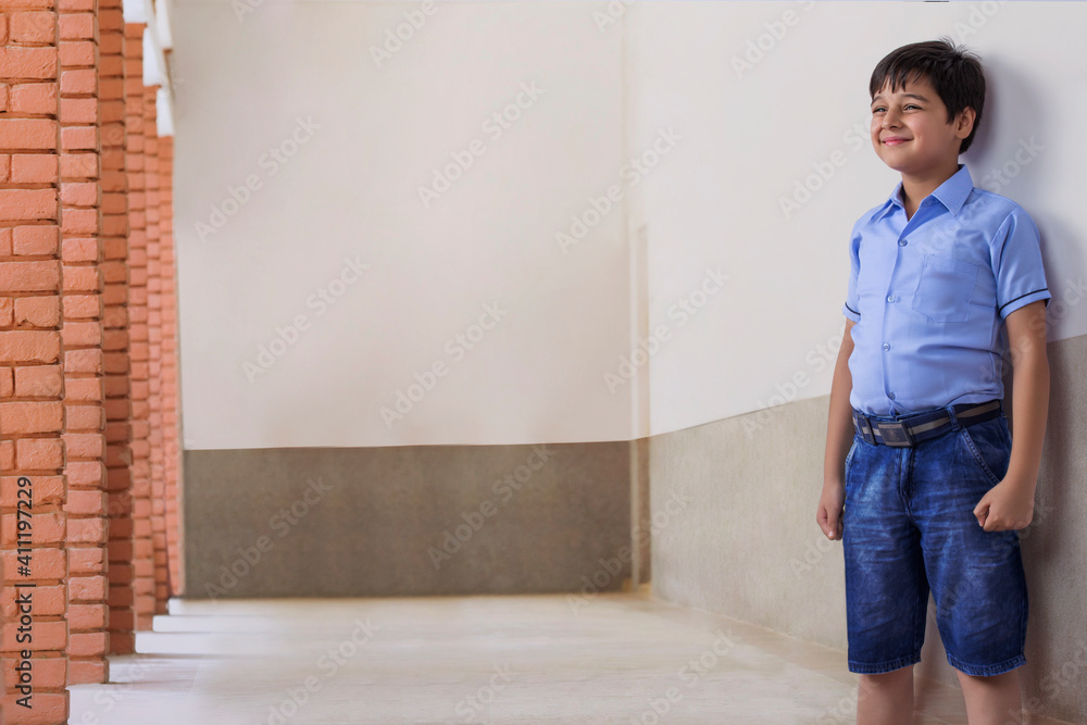 Obraz premium portrait of school boy standing outside the class