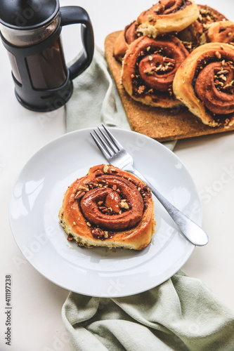 Cinnamon rolls buns on a white plate simple background  photo