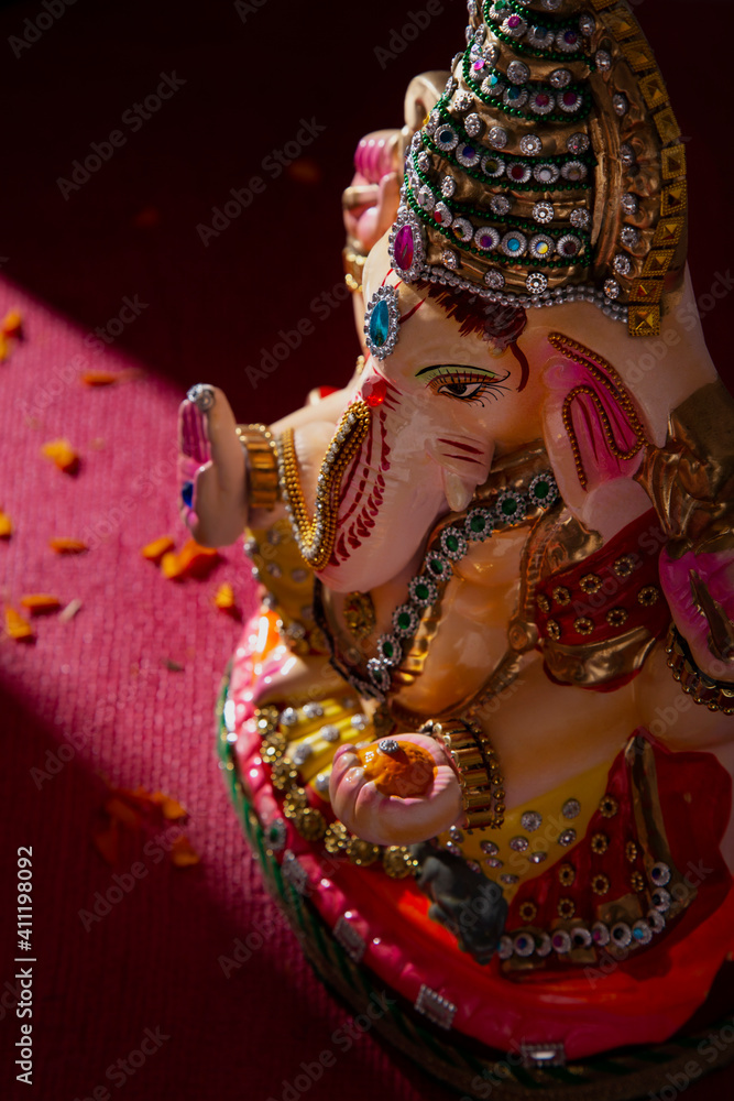 ganesh idol with flower petals	