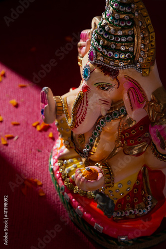 ganesh idol with flower petals 