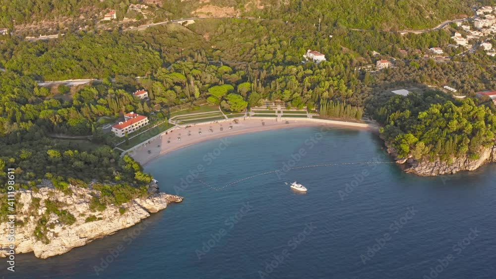 View on Milocer beach (Milocer Plaza) and Aman Villa Milocer (ex. Kralijicina Plaza), Montenegro. Sveti Stefan. Milocher. The beaches of the king and queen in Montenegro. Large white yacht in the bay View on Milocer beach (Milocer Plaza) and Aman Villa Milocer (ex. Kralijicina Plaza), Montenegro. Sveti Stefan. Milocher. The beaches of the king and queen in Montenegro. Large white yacht in the bay
