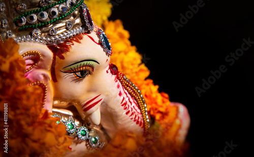 top shot of lord ganesha idol with flower garland 