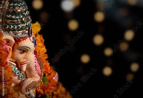 top shot of lord ganesha idol with flower garland 