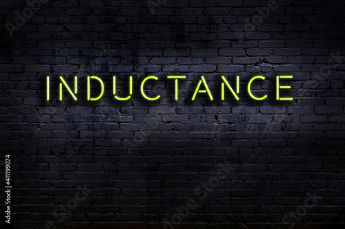 Принти на полотні Neon sign. Word inductance against brick wall. Night view