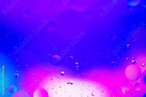 Abstract background pink and blue with oil drops in water 