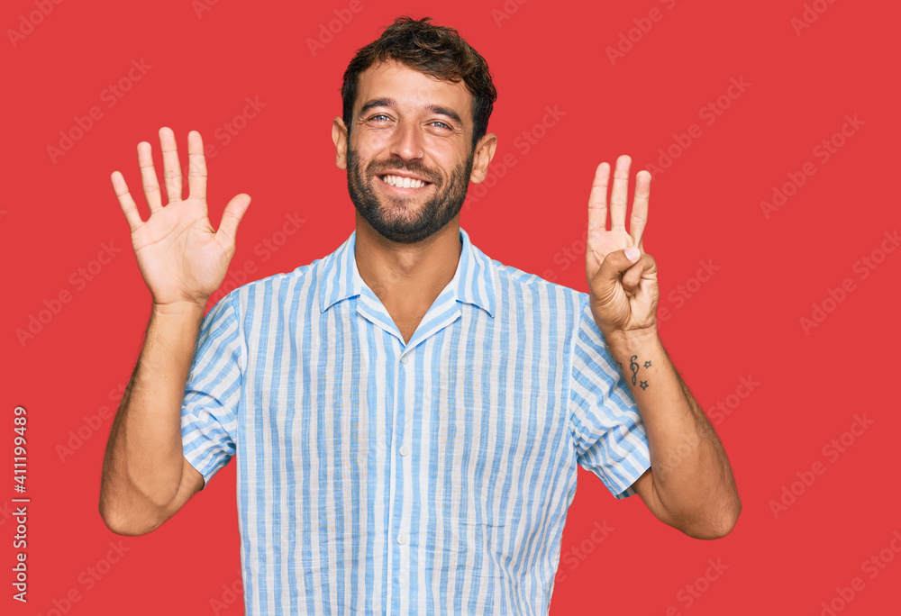 Naklejka premium Handsome young man with beard wearing casual fresh shirt showing and pointing up with fingers number eight while smiling confident and happy.
