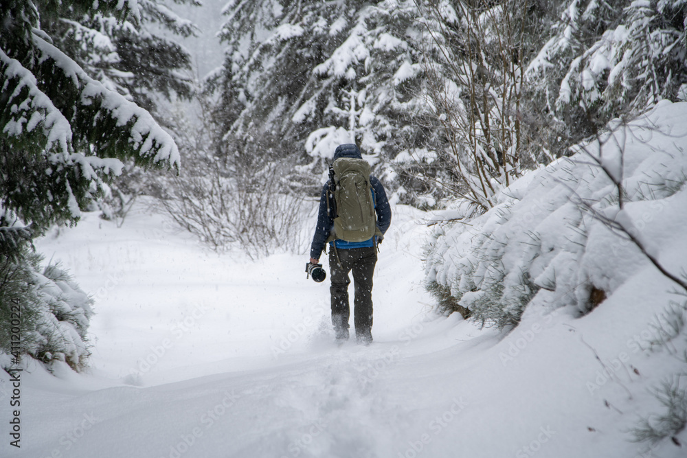 Man hiking in the mountains with snow