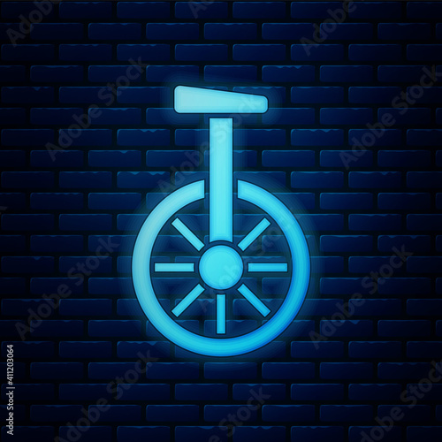 Glowing neon Unicycle or one wheel bicycle icon isolated on brick wall background. Monowheel bicycle. Vector.