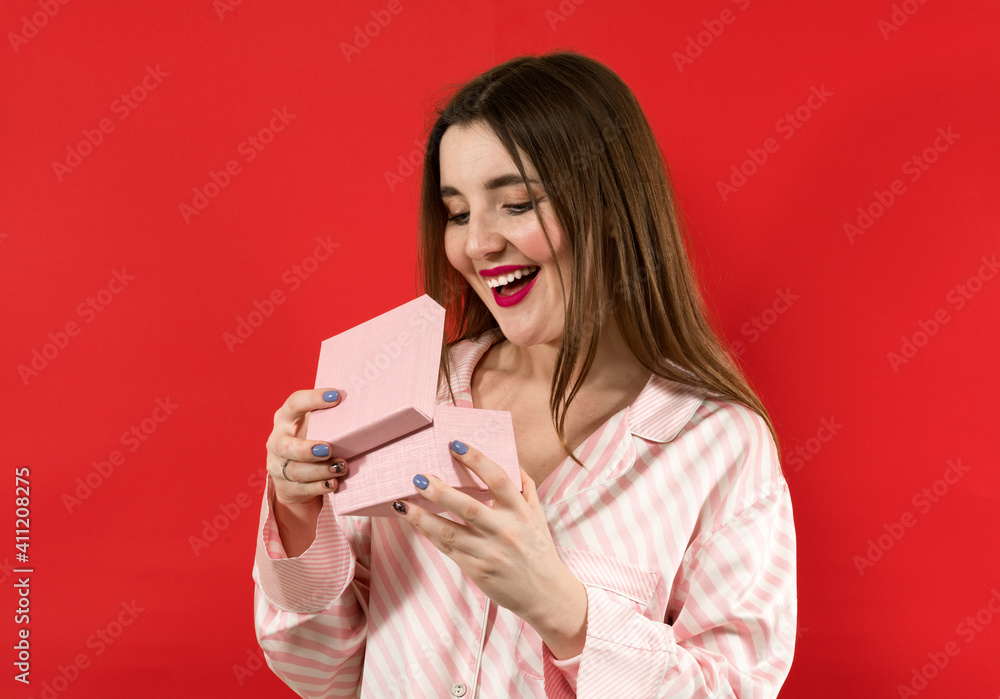 What a surprise. girl surprised excited holds gift box on red background. What a surprise. girl surprised excited holds gift box on red background.
