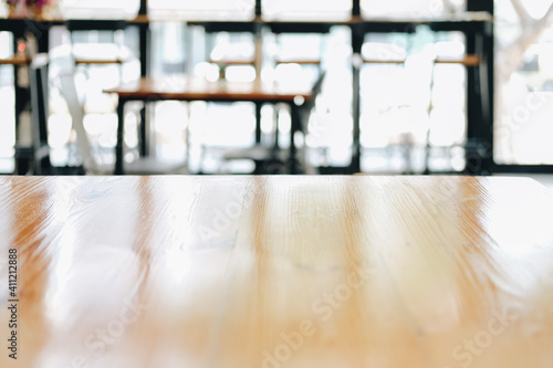wooden table with cafe coffee shop blur background