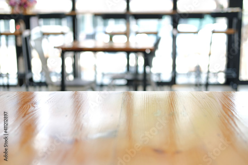 wooden table with cafe coffee shop blur background