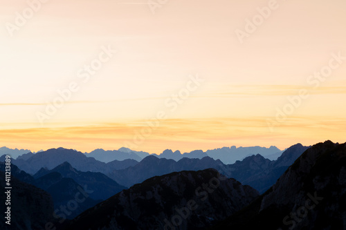Beautiful view of the Mangart mountains at sunset, in the background from the beautiful peak © rolandbarat