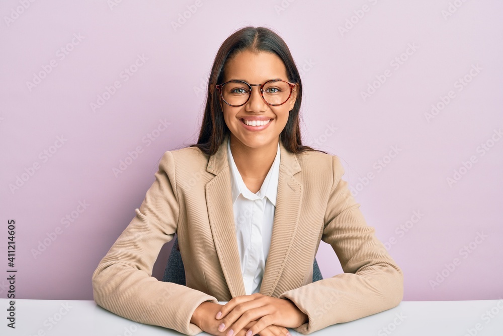 Beautiful hispanic woman working at the office with a happy and cool smile on face. lucky person. Beautiful hispanic woman working at the office with a happy and cool smile on face. lucky person.