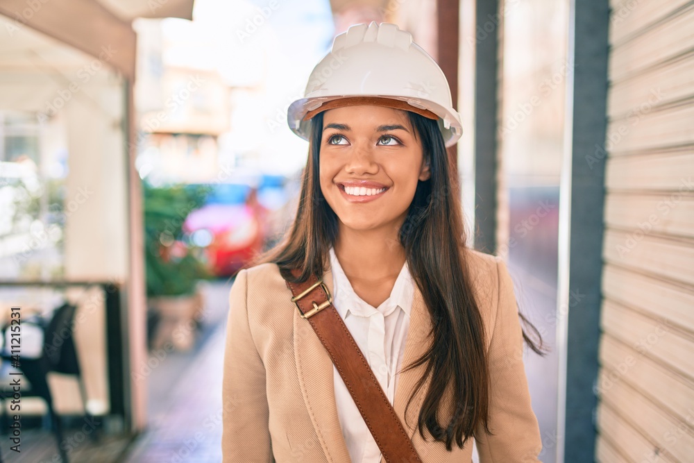 Young latin architect girl smiling happy standing at the city. Young latin architect girl smiling happy standing at the city.