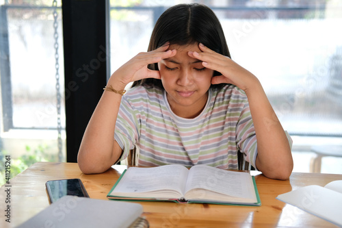 girl student studying hard feeling stressed tired exhausted bored. children education