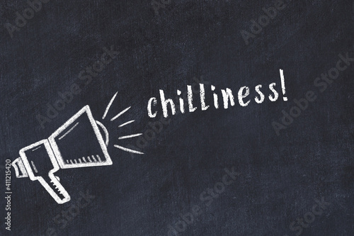 Chalk loudspeaker and inscription chilliness on black chalkboard