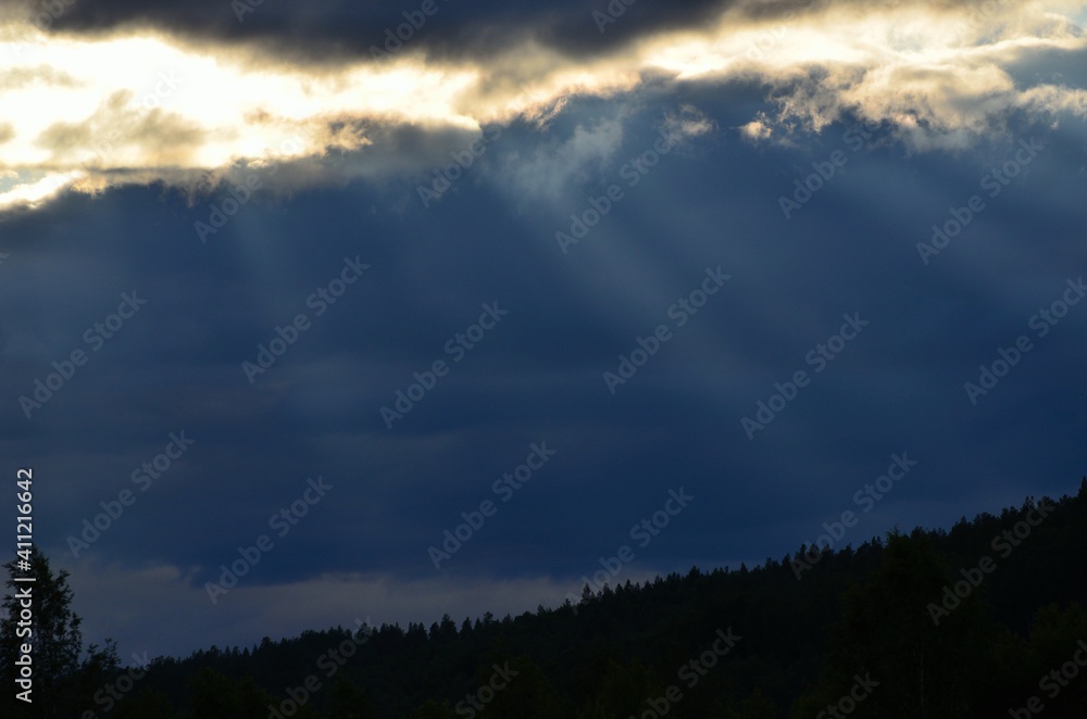 sunrays cutting through thick cloud cover