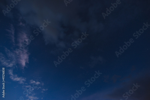 Obraz na płótnie Stars in the night sky through the clouds on a summer night w salonie