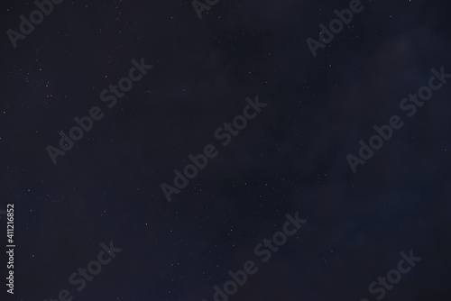 Obraz na płótnie Stars in the night sky through the clouds on a summer night w salonie