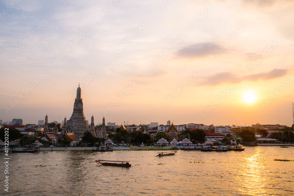 Wat Arun Ratchawararam, seen from the bank of the Chao Phraya River in the evening in Bangkok, Thailand.