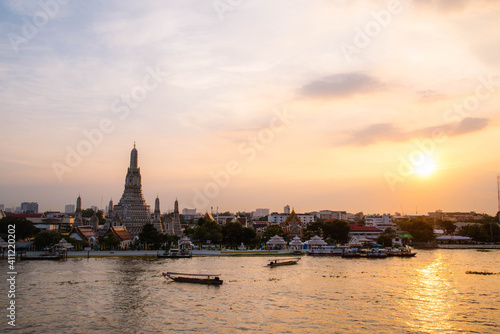 Wat Arun Ratchawararam, seen from the bank of the Chao Phraya River in the evening in Bangkok, Thailand.