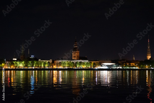 Riga city  panoramic view across Daugava river at night © Aalez
