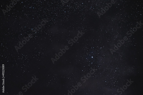 Stars in the night sky through the clouds on a summer night