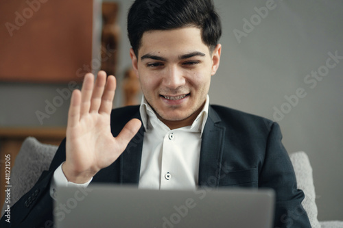 Wallpaper Mural the manager is a man in a business suit working on a laptop. He is working on a new project through a social network. The stylish office sits on a comfortable chair. work as an economist Torontodigital.ca