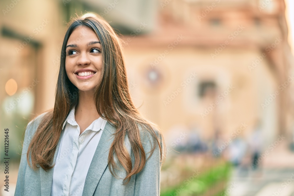 Young latin businesswoman smiling happy standing at the city. Young latin businesswoman smiling happy standing at the city.
