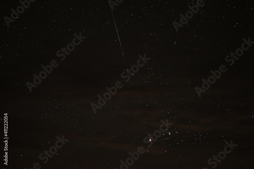 Stars in the night sky through the clouds on a summer night