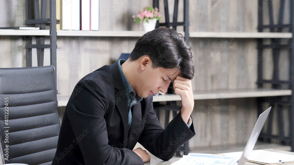 Asian businessman with frustrated and depressed expression while working office desk, office lifestyle Asian businessman with frustrated and depressed expression while working office desk, office lifestyle