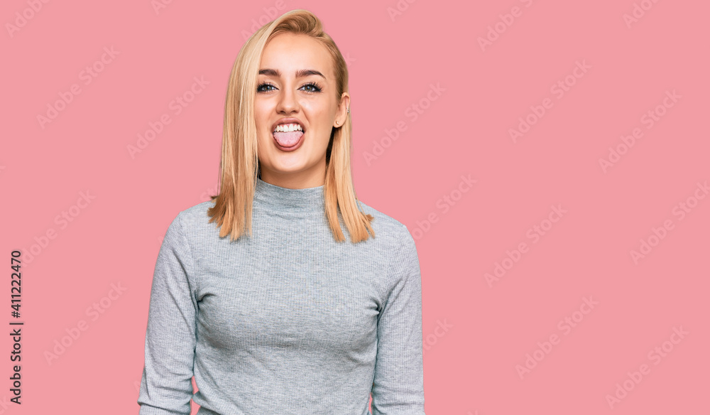Beautiful caucasian woman wearing casual clothes sticking tongue out happy with funny expression. emotion concept. Beautiful caucasian woman wearing casual clothes sticking tongue out happy with funny expression. emotion concept.