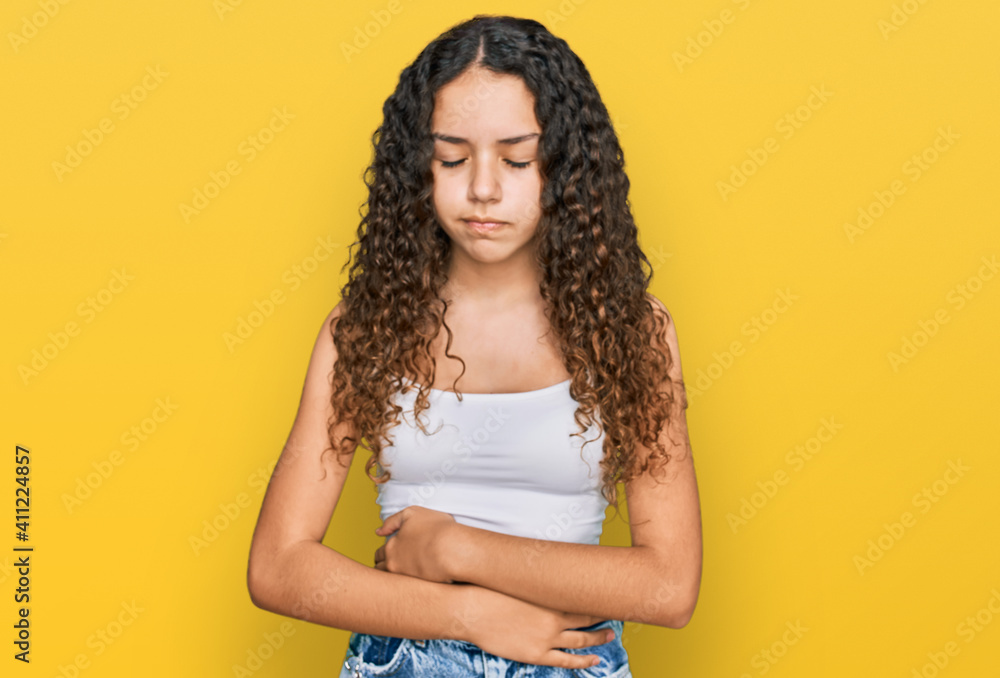 Teenager hispanic girl wearing casual clothes with hand on stomach because indigestion, painful illness feeling unwell. ache concept. Teenager hispanic girl wearing casual clothes with hand on stomach because indigestion, painful illness feeling unwell. ache concept.