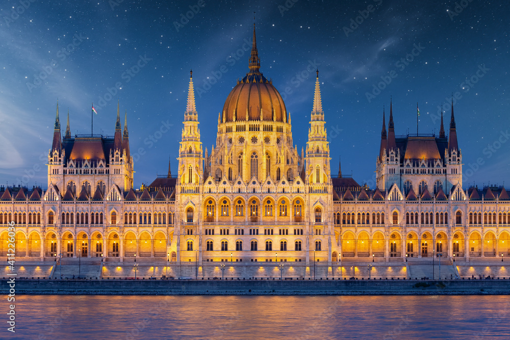 Hungarian Parliament along river Danube at dawn with starry sky
